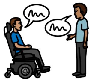 Two men talking at the same time, one is a wheelchair user.